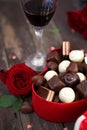 Chocolates in a heart shaped box and a bunch of red roses on woo Royalty Free Stock Photo